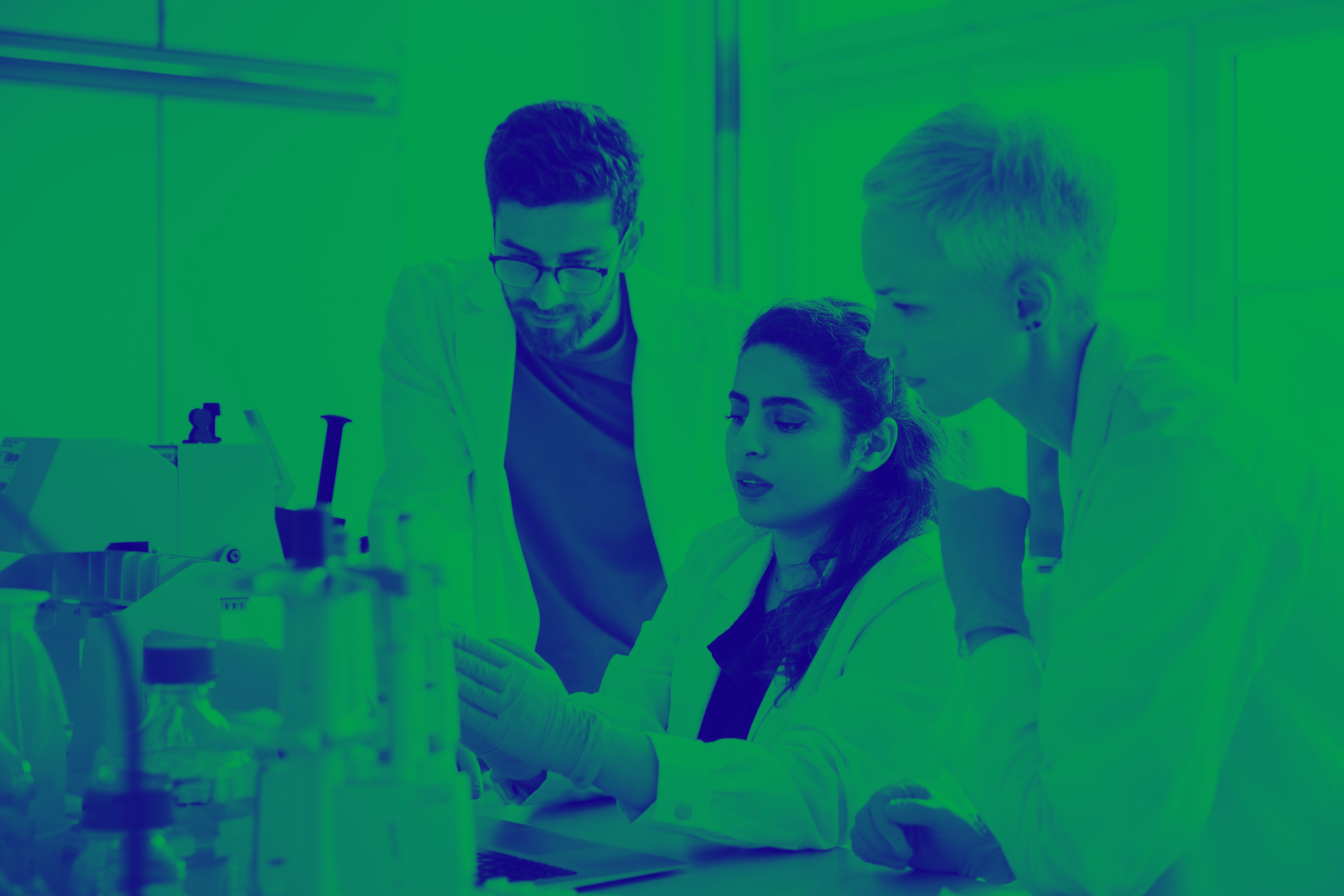 Green and blue washed image of people in a lab