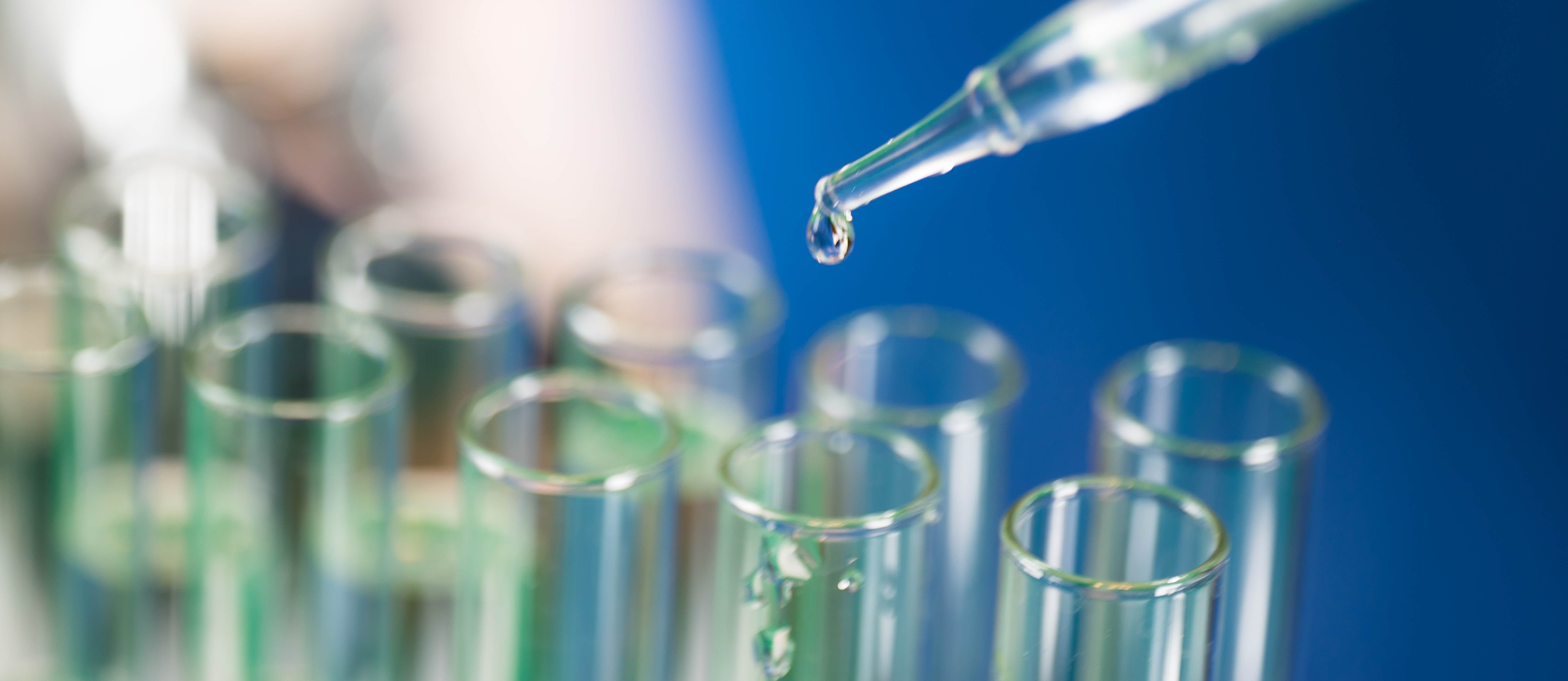 liquid being dropped into test tubes