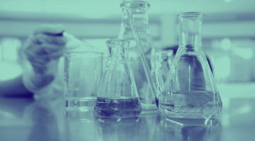 Blue washed image of beakers in a lab