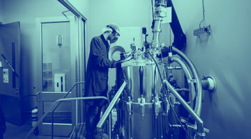 Blue washed image of male in lab with sterile tank