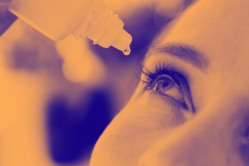 orange washed image of drop being made into eye