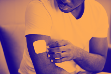 orange washed image of patch being applied to upper arm