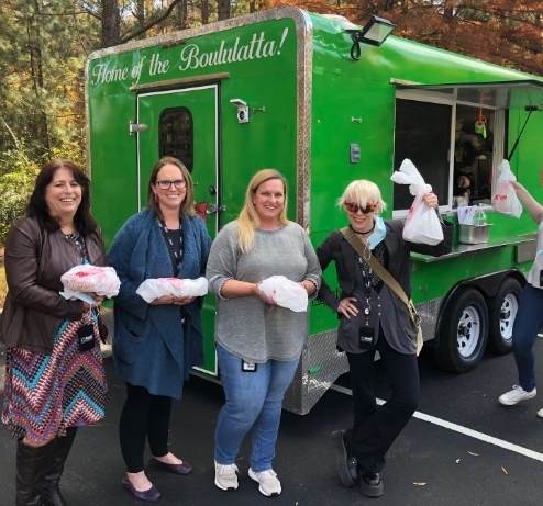Avanti Research staff outside of a food truck