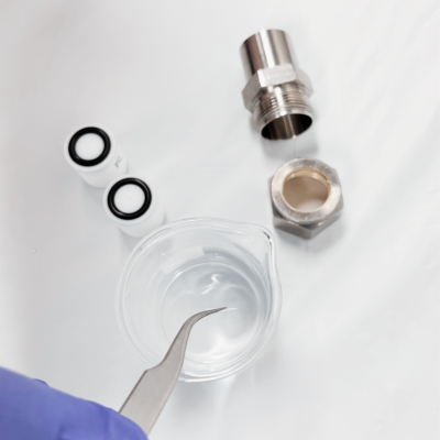 Mini Extruder Pro Pre-wet a filter support with DI water, or buffer, and center inside the o-ring.    The filter support should adhere to the teflon orifice inside the O-ring inner diameter. 