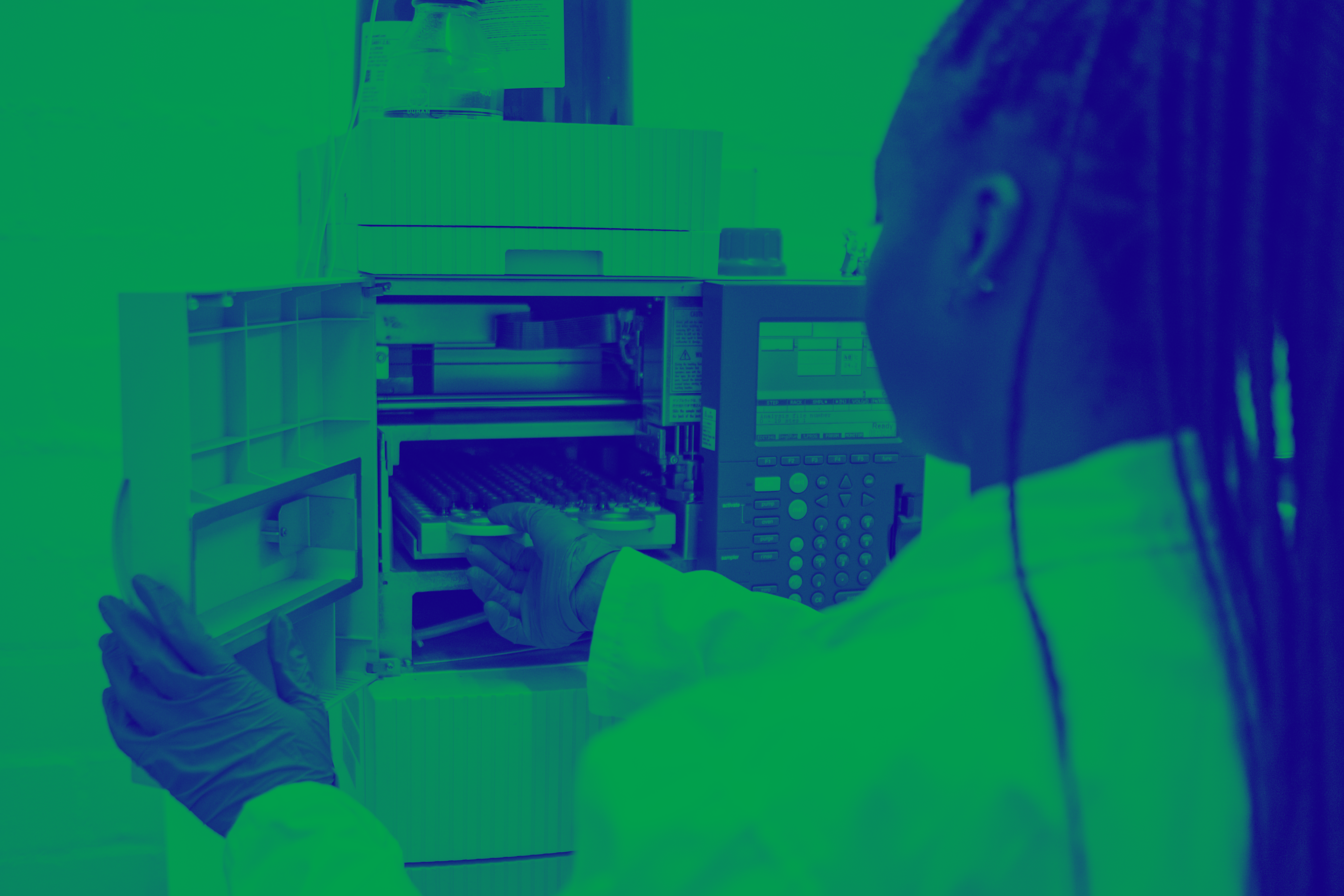 green and blue washed image of female in lab