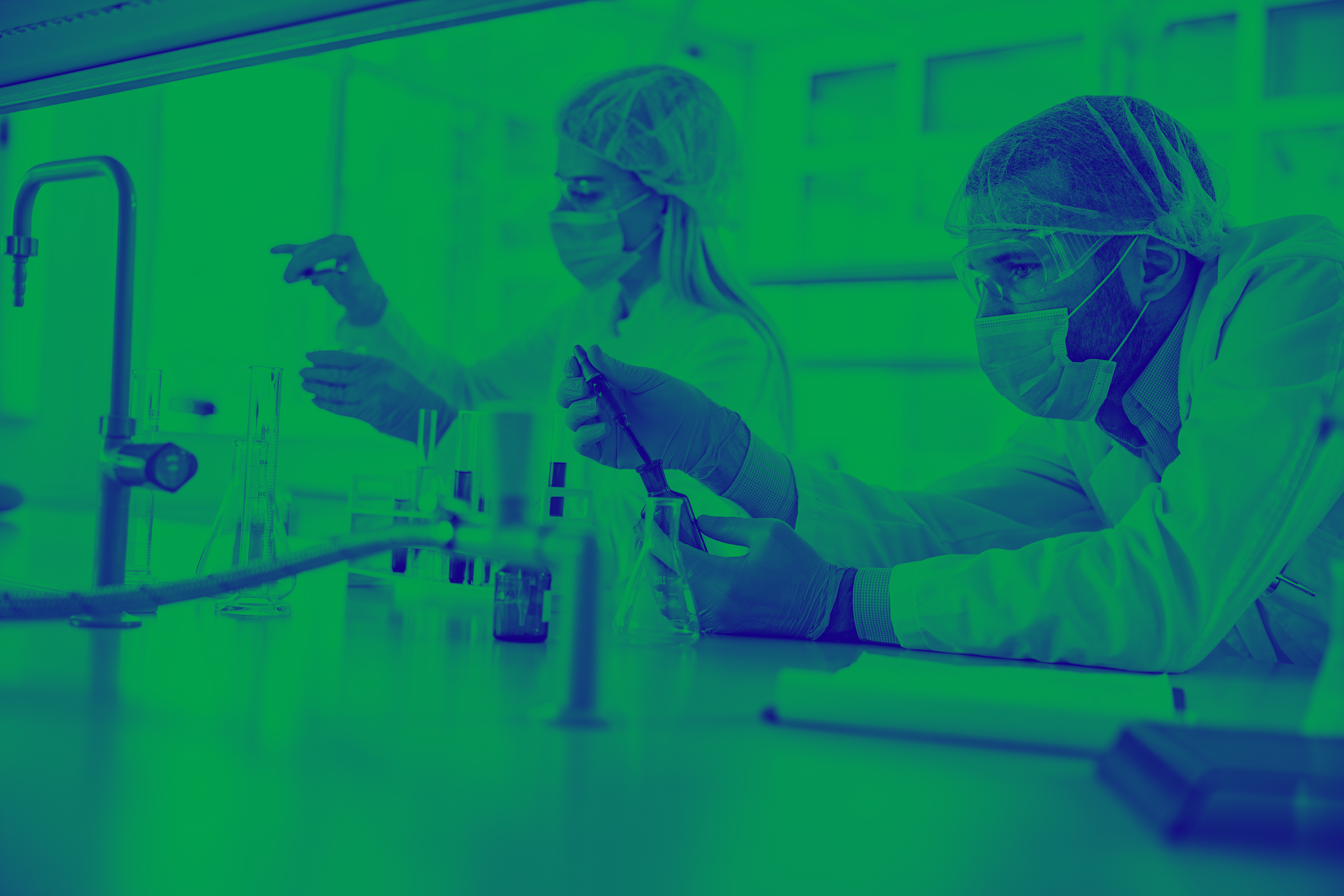 Blue and green washed image of male and female in lab